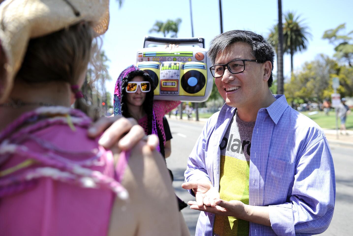 State Treasurer John Chiang, a Democratic candidate for governor, speaks with local resident Kimi Vandyk during a campaign stop at the Summer Solstice Festival in Santa Barbara on June 24.