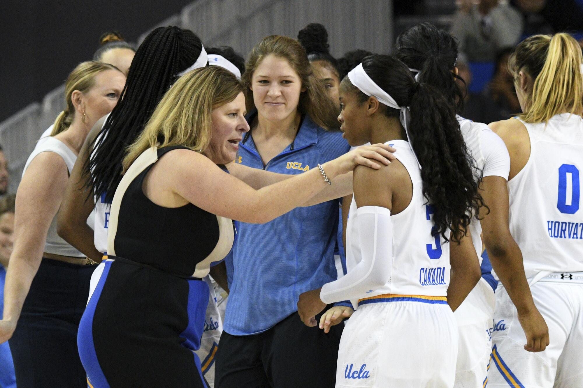 UCLA coach Cori Close talks with Jordin Canada during a timeout.