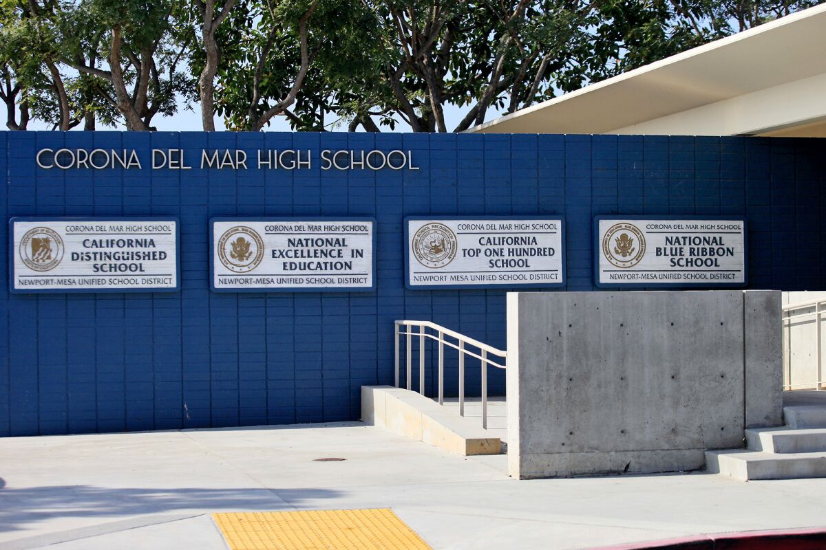 A ninth-grader was arrested following an after-school fight Thursday at Corona del Mar High School in which a seventh-grader was injured. The younger boy's mother said he suffered head fractures.