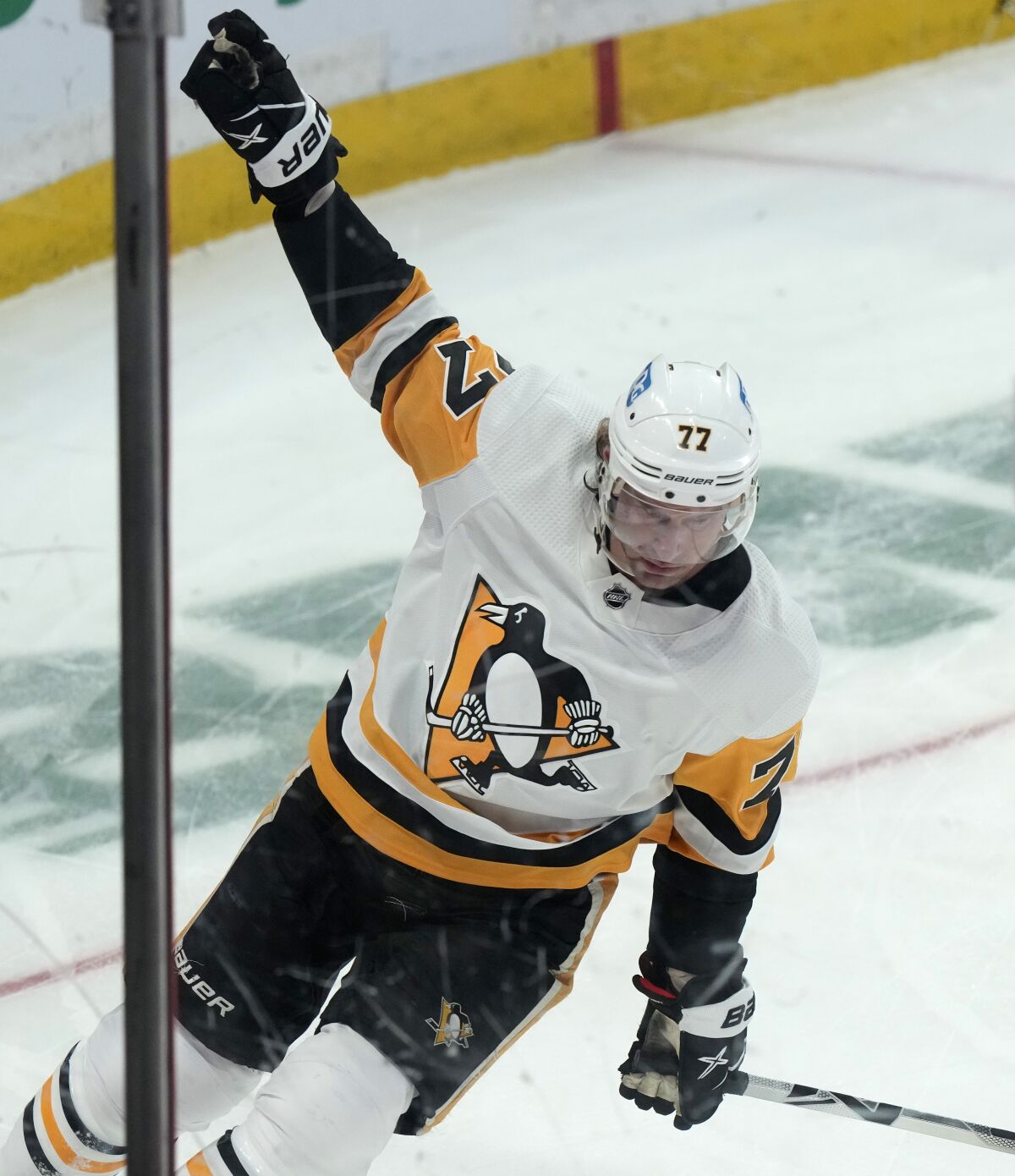 Pittsburgh Penguins center Jeff Carter celebrates his goal against the Ottawa Senators during second-period NHL hockey game action, Thursday, Feb. 10, 2022, in Ottawa, Ontario. (Adrian Wyld/The Canadian Press via AP)