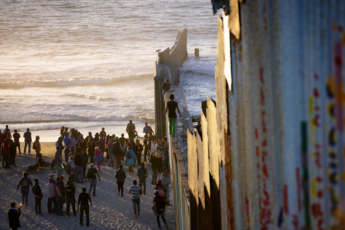 Migrants who arrived as part of a caravan from Central America to seek asylum in the U.S. gather at Playas de Tijuana