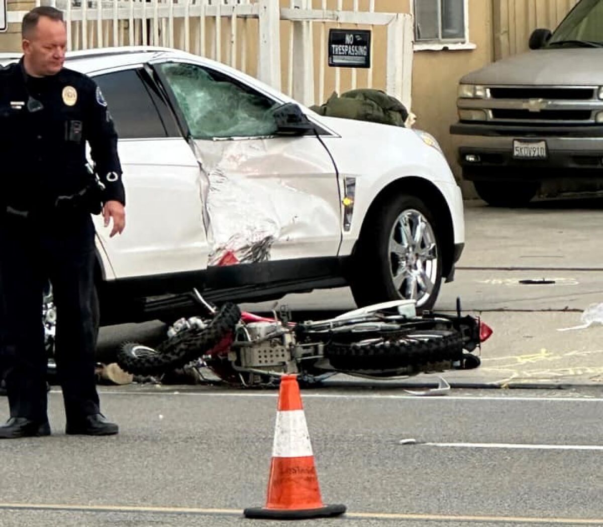 A Costa Mesa police officer inspects the scene of a crash on Placentia Avenue.