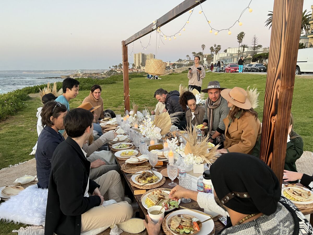 About 20 strangers meet for a sunset dinner party Feb. 5 at Cuvier Park in La Jolla.