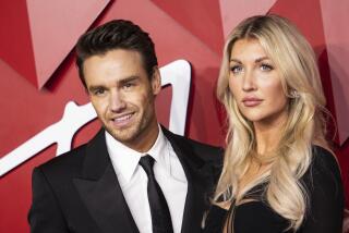 Liam Payne and Kate Cassidy pose for photographers at the British Fashion Awards