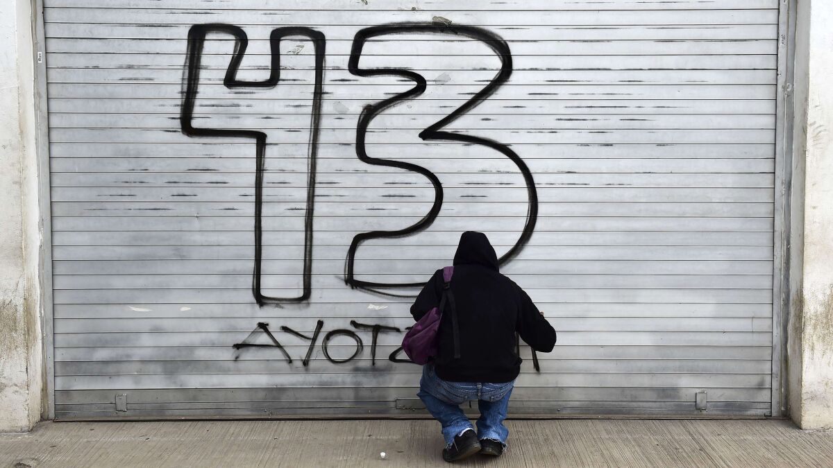 Since the 43 students disappeared, the numeral has become a symbol — of resistance to corruption, violence and a broken justice system. In this image, a masked man sprays a graffito in honor of the 43.