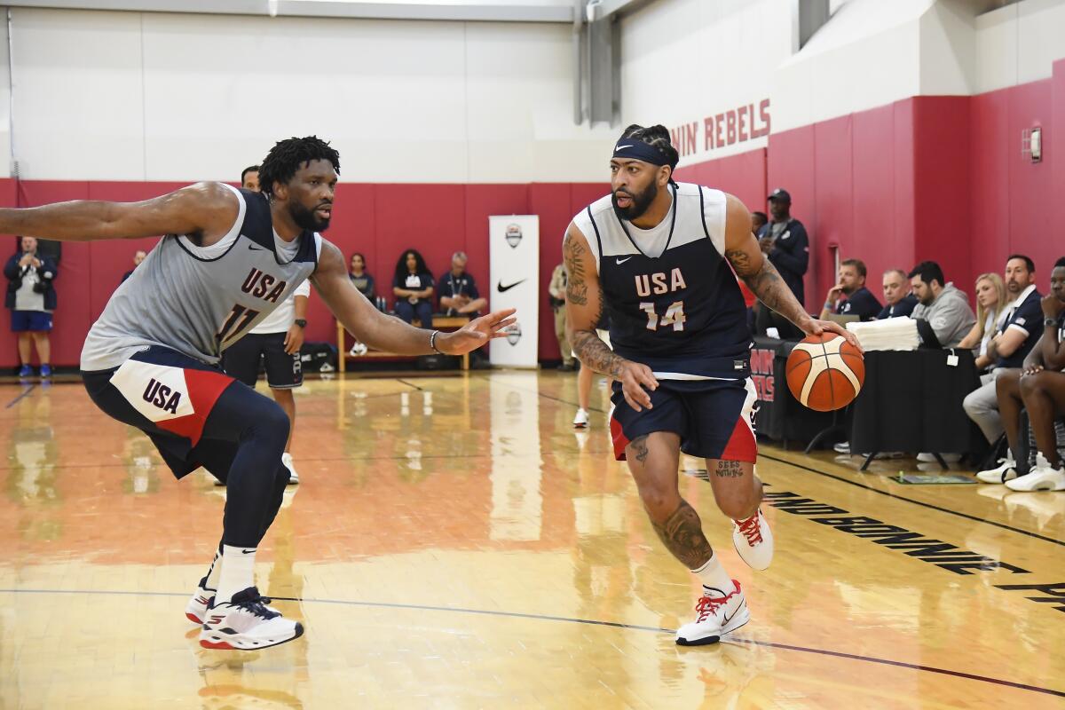 Lakers star Anthony Davis, right, drives against 76ers center Joel Embiid during a Team USA practice Saturday in Las Vegas.