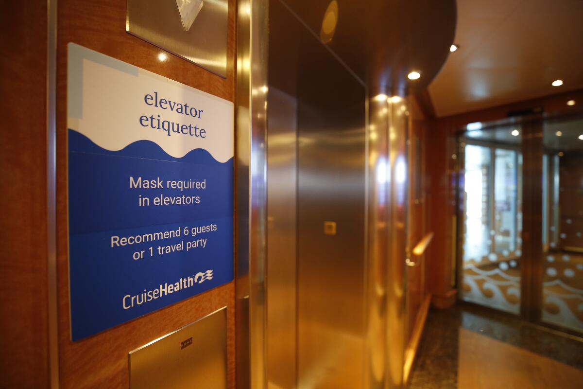 A sign on the Majestic Princess cruise ship says masks are required in elevators.