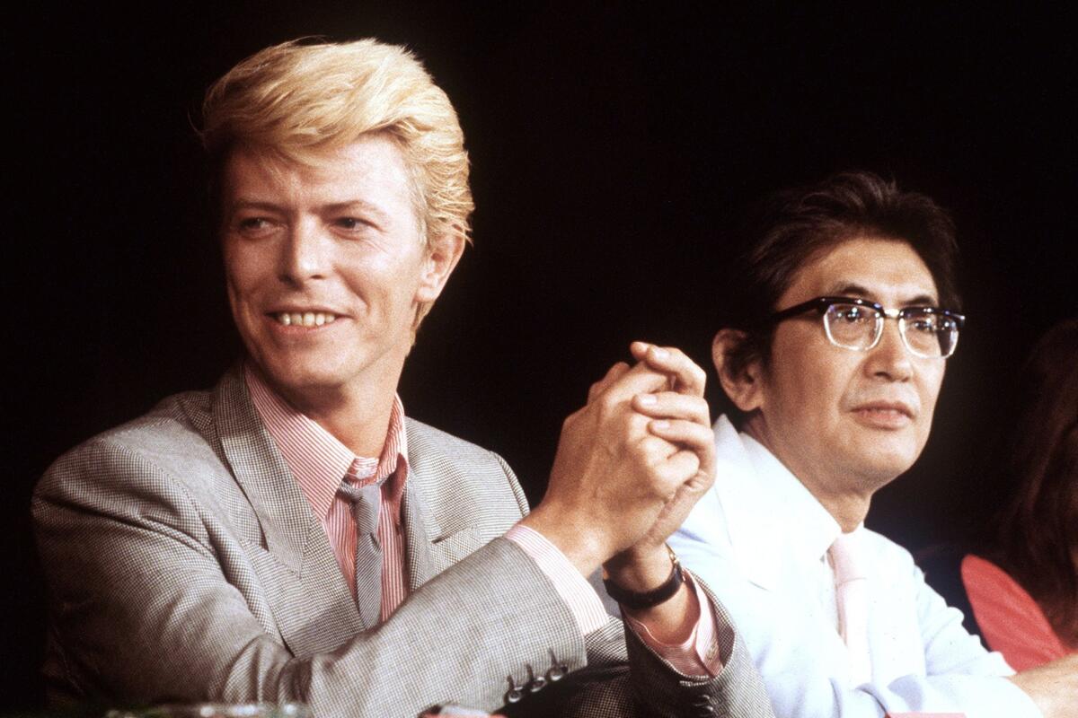 British singer and actor David Bowie gives a press conference presenting the Japanese movie "Merry Christmas Mr. Lawrence" directed by Nagisa Oshima (L) on May 11, 1983 during the 36th International Film Festival in Cannes.