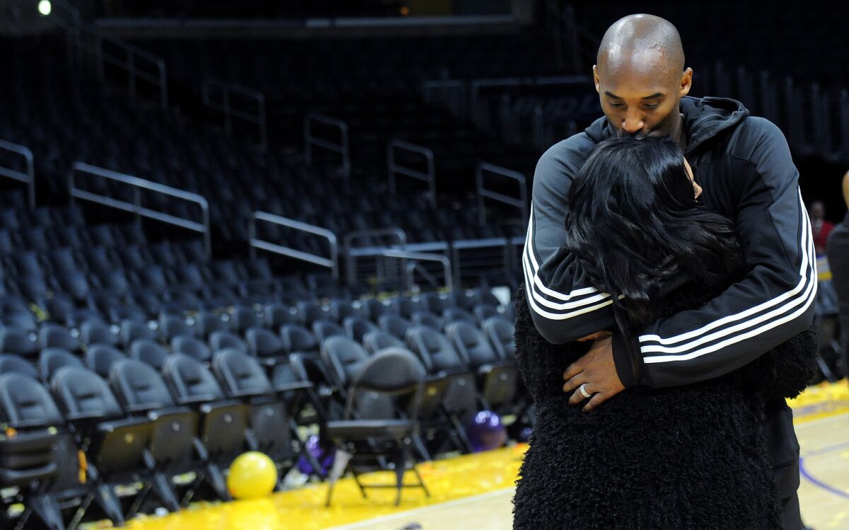 Kobe Bryant kisses his wife Vanessa long after his last game at Staples Center.