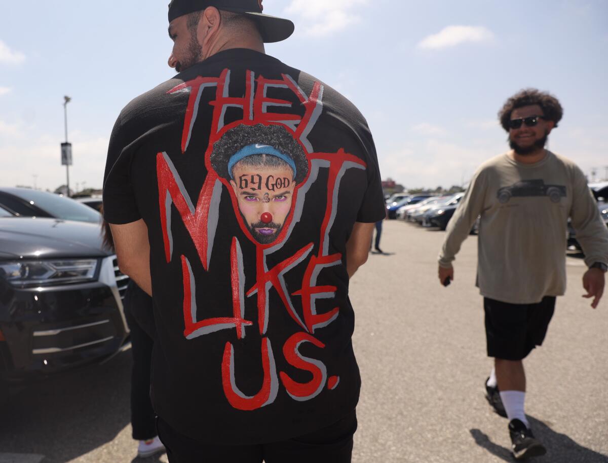 man in "They don't like us" Drake clown shirt