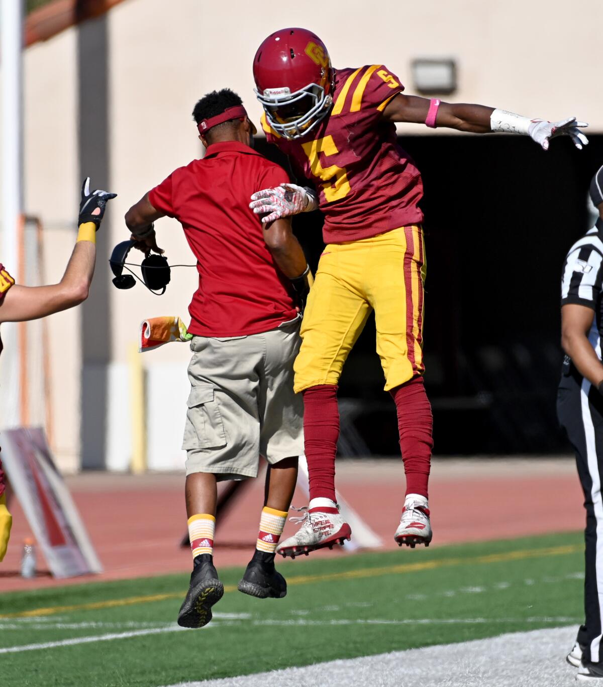 Torres Ingraham #5 of Glendale Community College celebrates with a coach after a touchdown against against Compton In the second half of a football game at Glendale Community College on Saturday, Oct. 19, 2019 in Glendale, California. (Photo by Libby Cline)