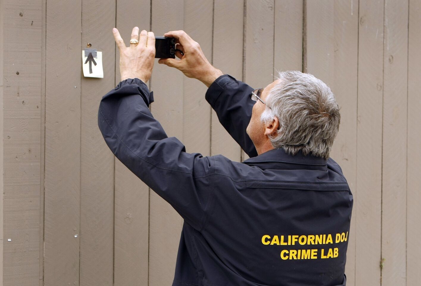 An investigator from the California Department of Justice Crime Lab collects evidence on Sabado Tarde Road on May 24 after the shooting rampage in Isla Vista.