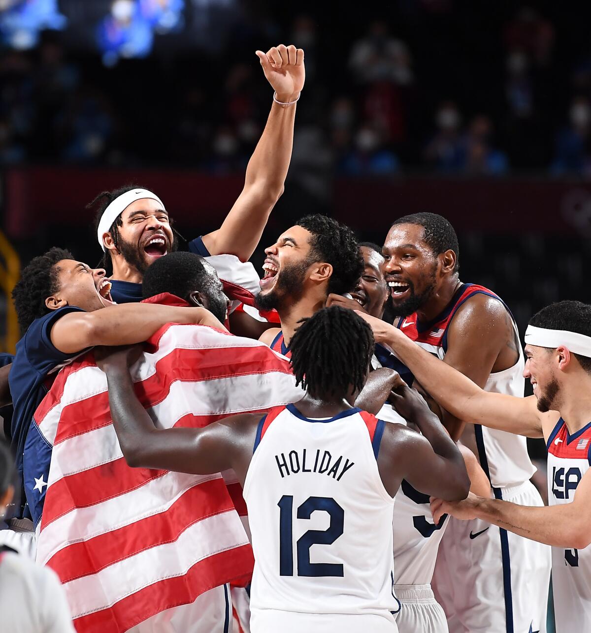 Players on the U.S. men's basketball team celebrate their gold-medal victory over France.