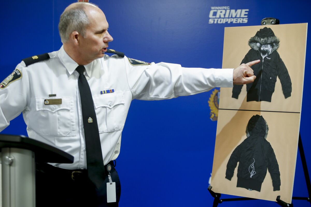 Winnipeg Police Inspector Shawn Pike provides an update to an ongoing homicide investigation in Winnipeg, Manitoba, Thursday, Dec. 1, 2022. Police alleged Thursday that Jeremy Skibicki, of Canada, previously charged with murdering an Indigenous woman also killed three other women — two also confirmed to be Indigenous and one believed to be. Pike shows a jacket that may help identify the fourth subject. (John Woods/The Canadian Press via AP)