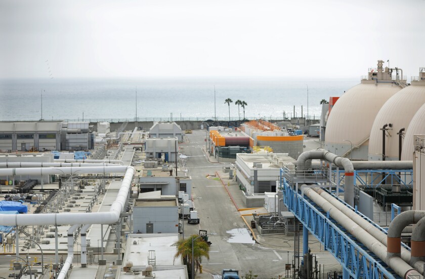 A network of pipes and storage tanks overlook the ocean