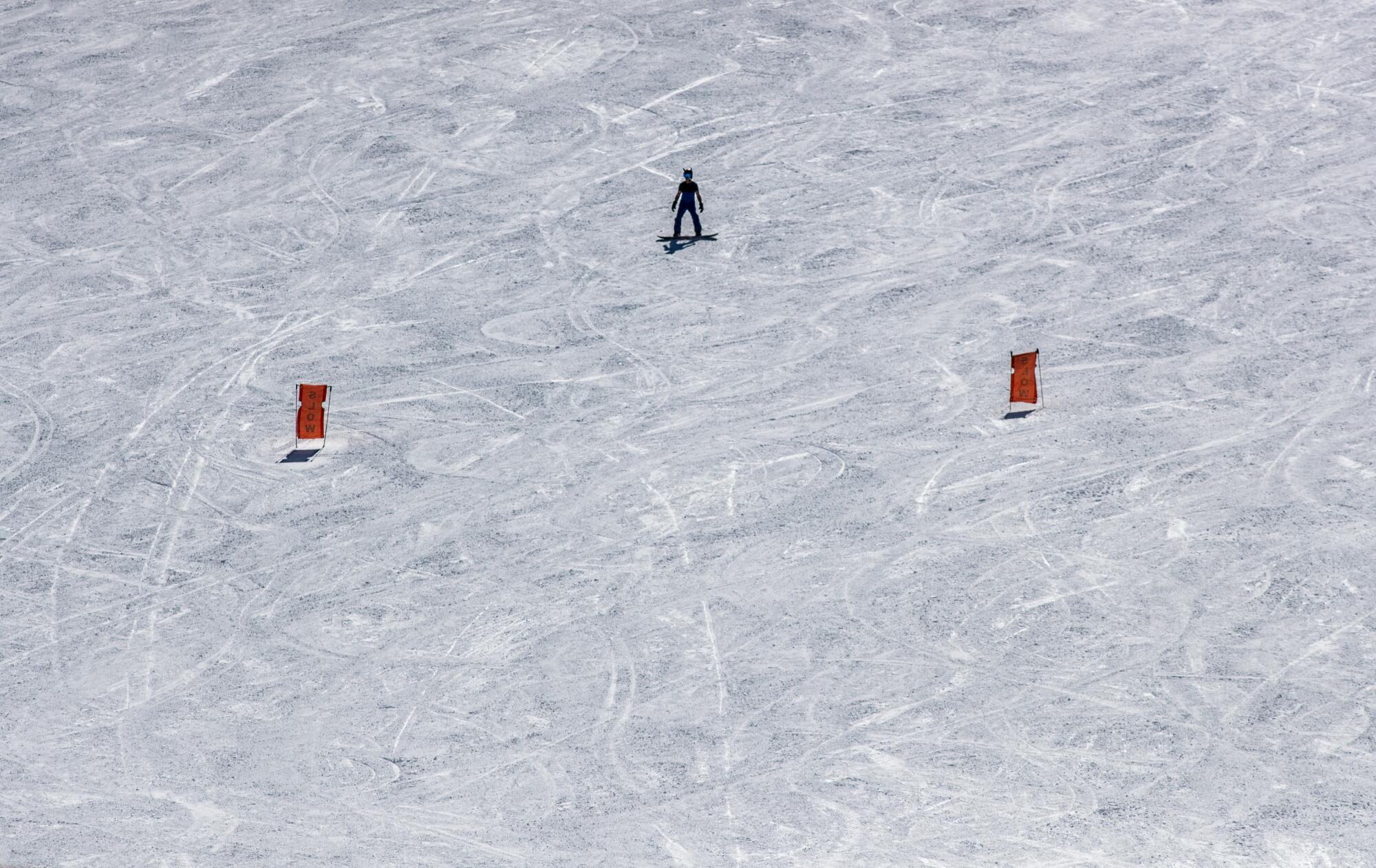 A lone snowboard an empty slope 