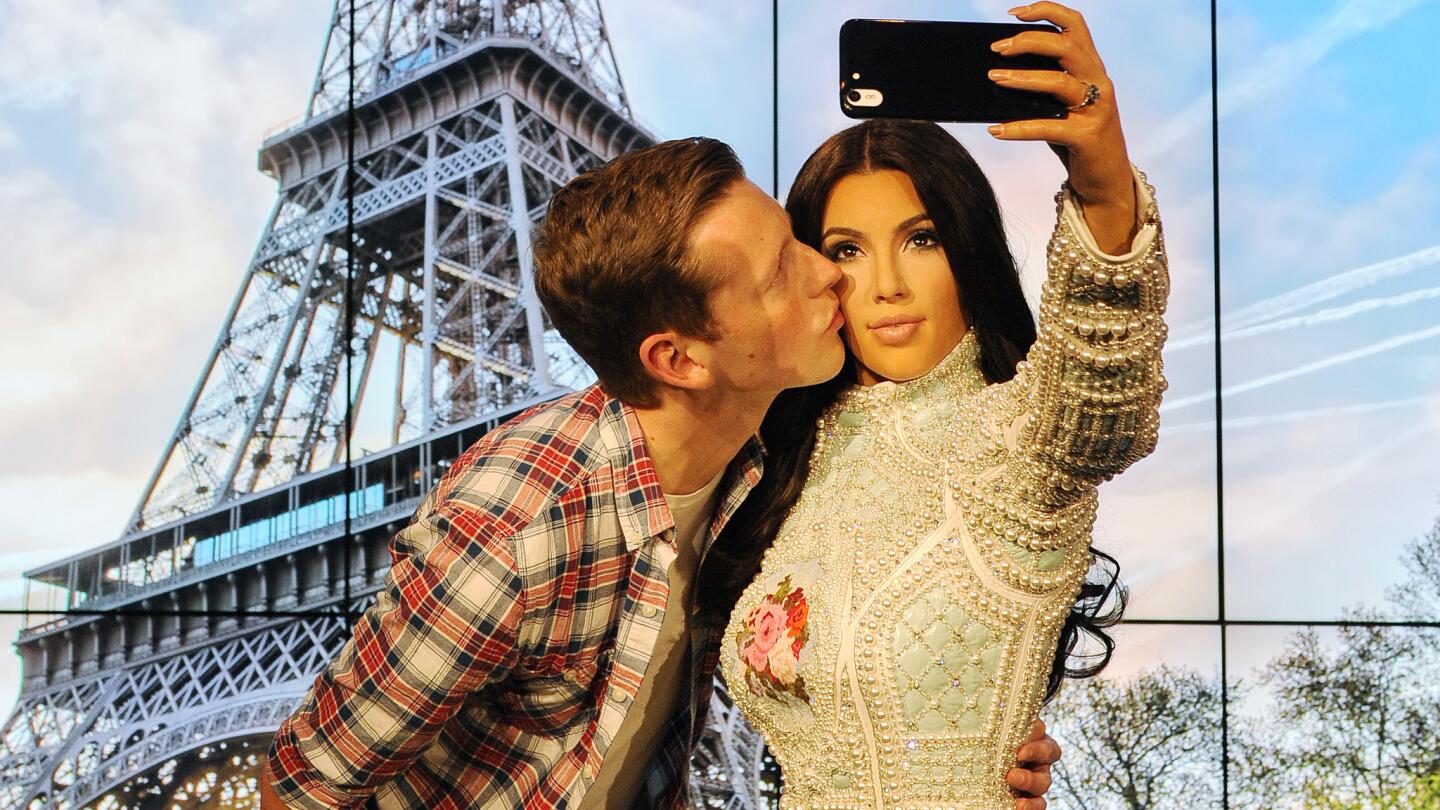 Madame Tussauds in London has unveiled a new wax figure of Kim Kardashian, which takes selfies against changing location backdrops. Fan Alex Cameron shows his appreciation.