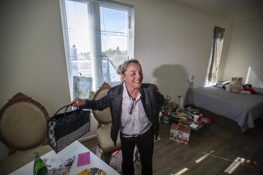 LOS ANGELES, CALIF. -- TUESDAY, MARCH 26, 2019: Rosa Duran, who was living on the streets for more than three years, shows her excitement over her new apartment as she gives the media a tour during the grand opening of the PATH Metro Villas, a supportive-housing development that houses formerly homeless individuals in Los Angeles, Calif., on March 26, 2019. "I had it all, I lose it all," Duran said, who had a home for 27 years. "I still feel like i'm falling off a bench when i sleep." The 65-unit complex will feature community rooms, counseling and case management offices and a Veterans Connections Center. (Allen J. Schaben / Los Angeles Times)