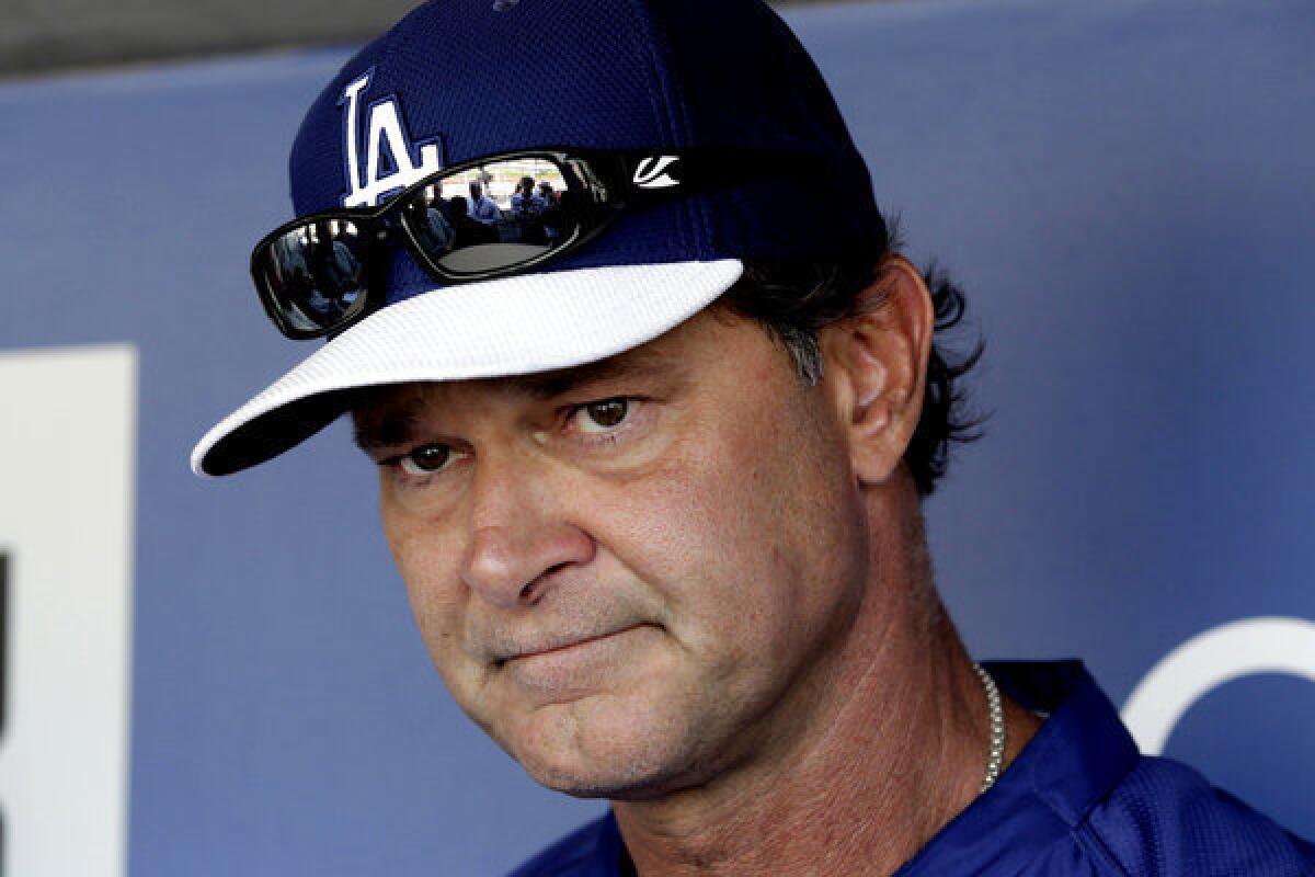 Los Angeles Dodgers Manager Don Mattingly talks with reporters before a game against the Miami Marlins.