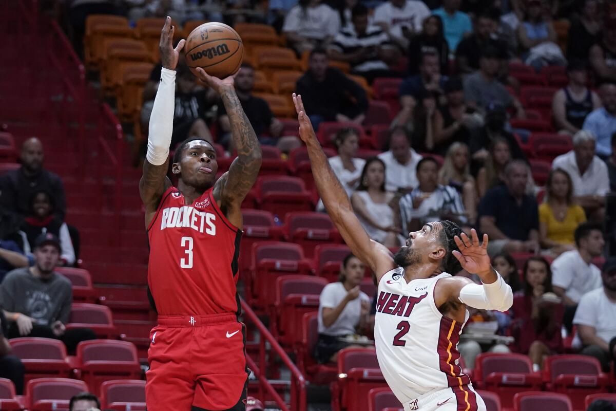 Houston Rockets guard Kevin Porter Jr. (3) takes a shot against Miami Heat guard Gabe Vincent (2) during the first half of a preseason NBA basketball game, Monday, Oct. 10, 2022, in Miami. (AP Photo/Wilfredo Lee)