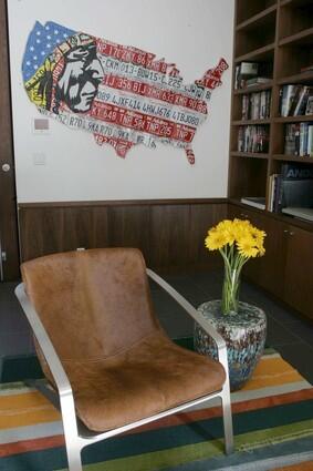 An armchair rests among bookshelves