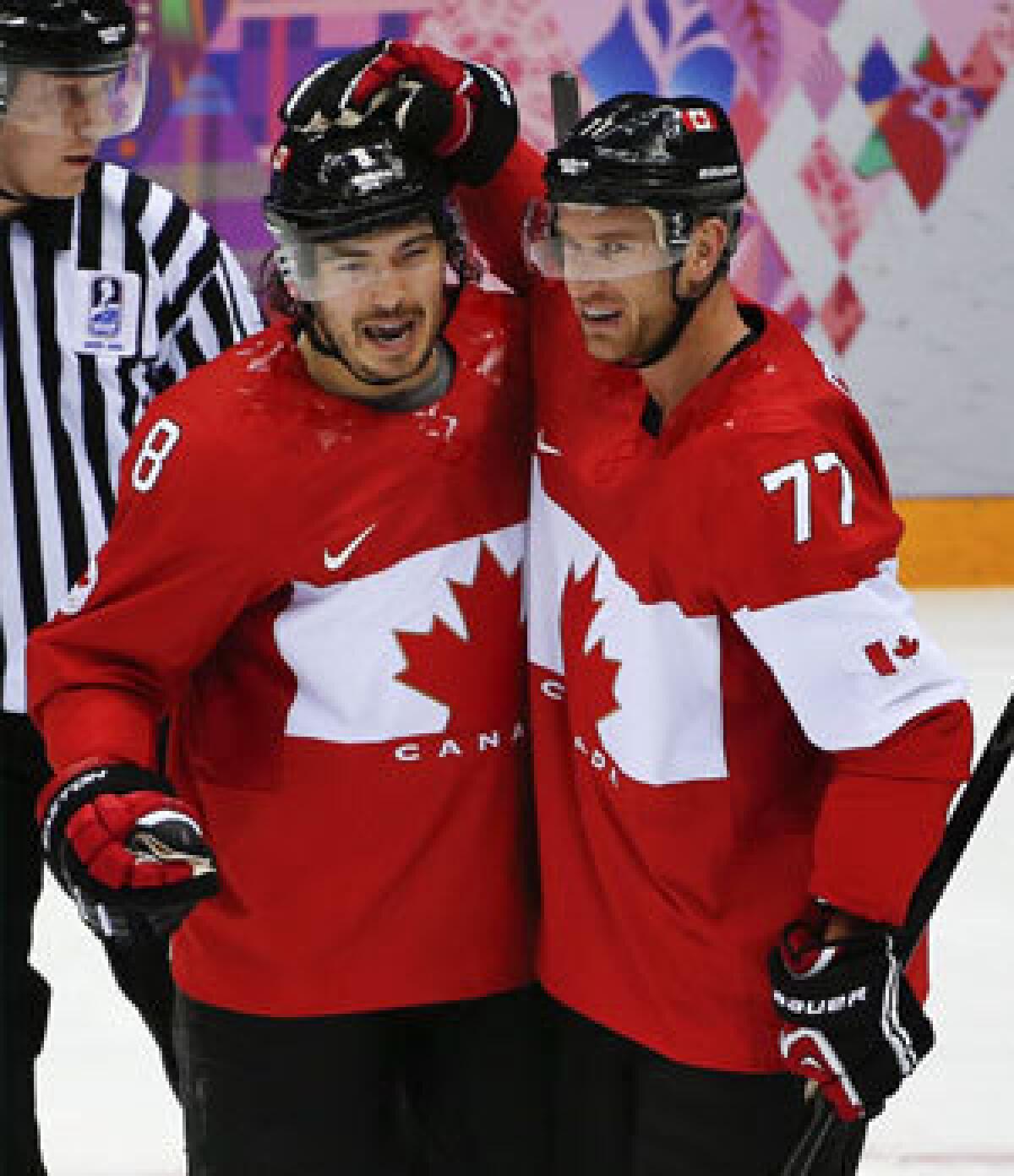 Drew Doughty, left, and Jeff Carter aren't fans of the wider Olympics ice.