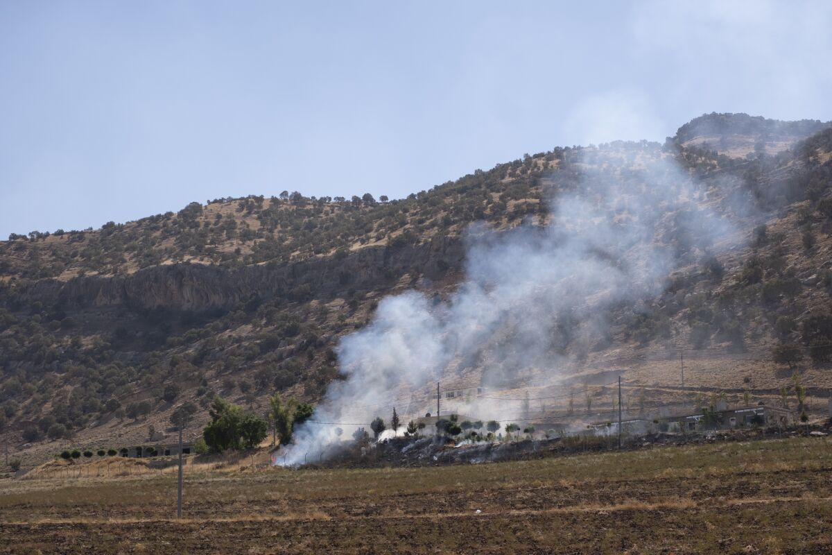 Smoke billows in the village of Zrgoiz, near Sulaimaniyah, Iraq, where the bases of several Iranian opposition groups are located, Wednesday, Sept. 28, 2022. An Iranian drone bombing campaign targeting the bases of an Iranian-Kurdish opposition group in northern Iraq has killed nd wounded dozens. (AP PhotoAla Hoshyar, Metrography)