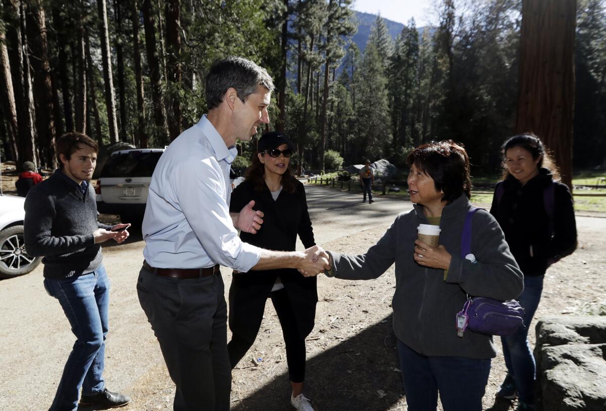 Former Texas congressman Beto O'Rourke, left, meets Myrna McCarthy of Honolulu on Monday in Yosemite National Park during the Democratic presidential candidate's tour through California.