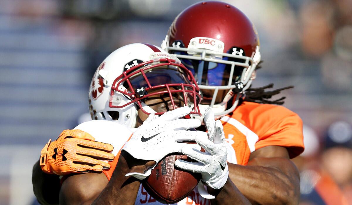 USC defensive back Josh Shaw tries to defend the ball against Stanford wide receiver Ty Montgomery during practice for the Senior Bowl on Wednesday.