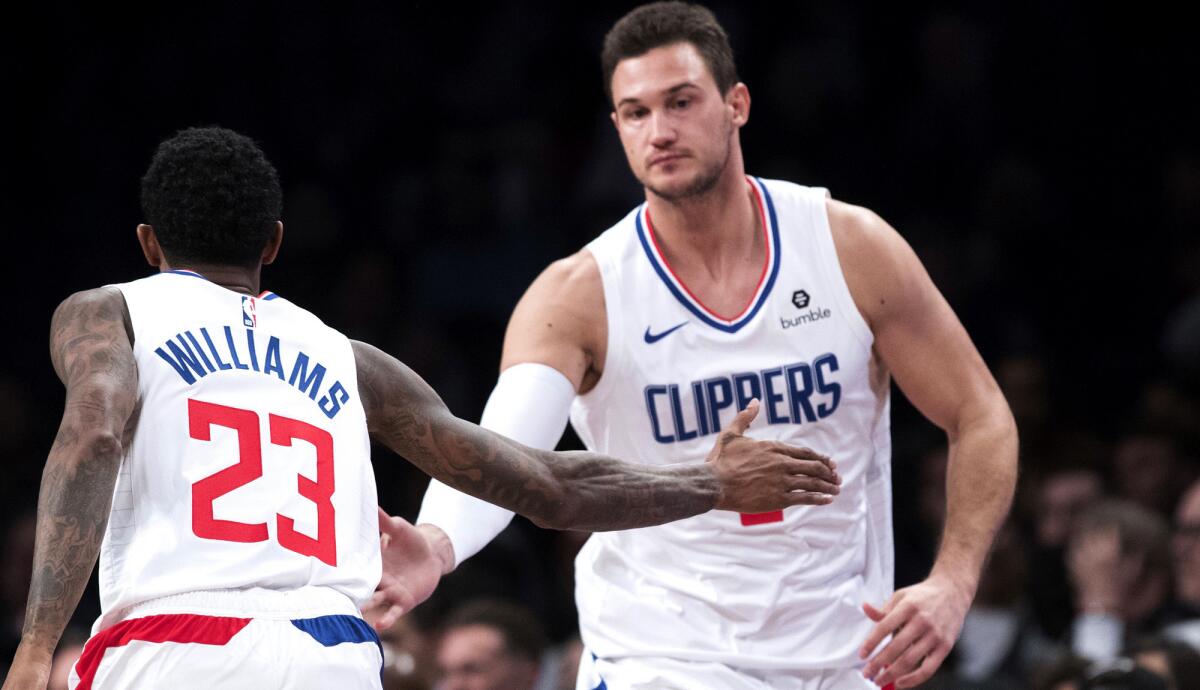 Forward Danilo Gallinari, being congratulated by guard Lou Williams after scoring against Brooklyn on Nov. 17, is cautioning that the Clippers have a long road ahead despite a strong start.