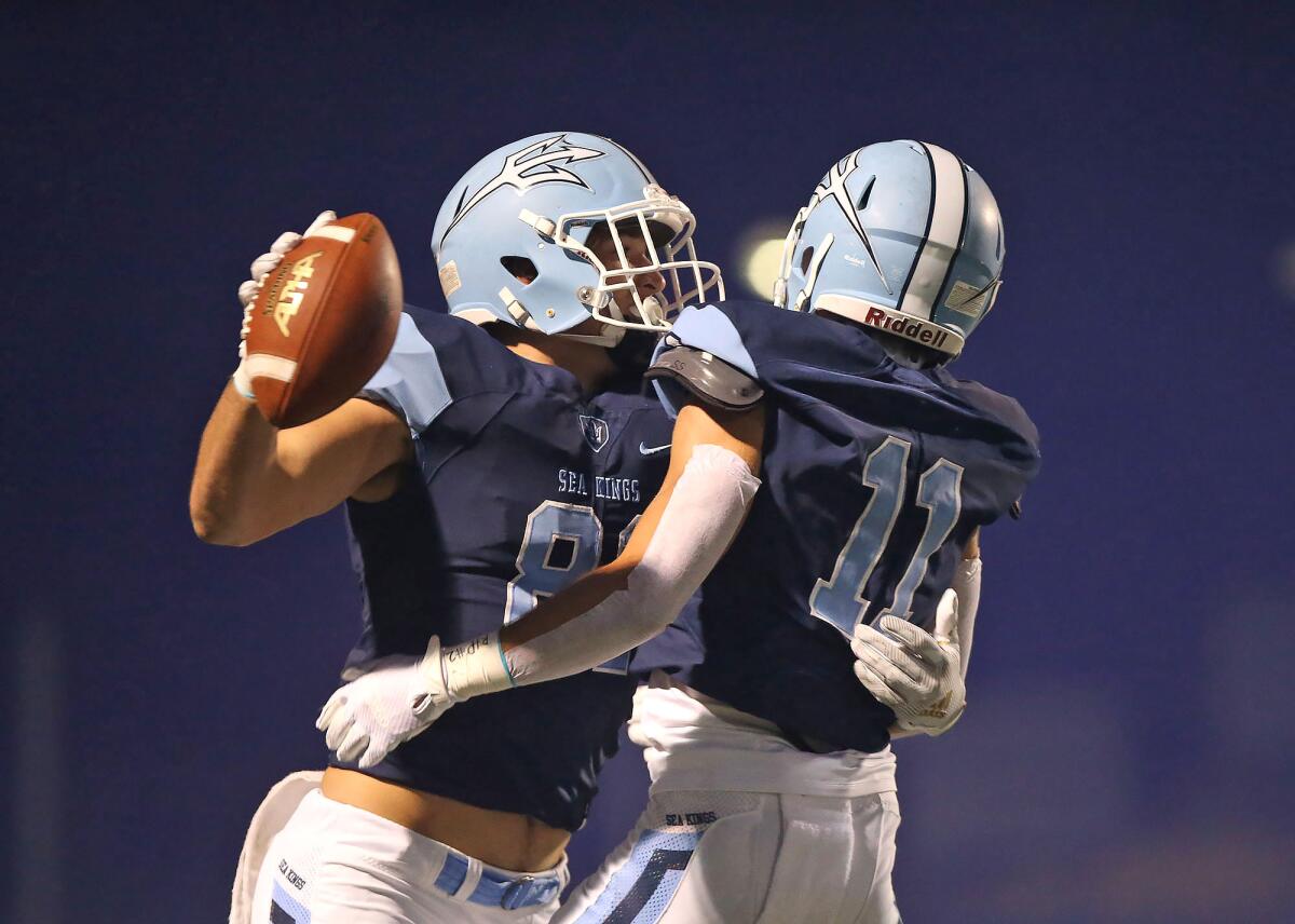 Corona del Mar's Mark Redman, left, and Bradley Schlom celebrate Redman's 37-yard touchdown catch 17 seconds into a Sunset League game against Los Alamitos on Friday at Davidson Field.