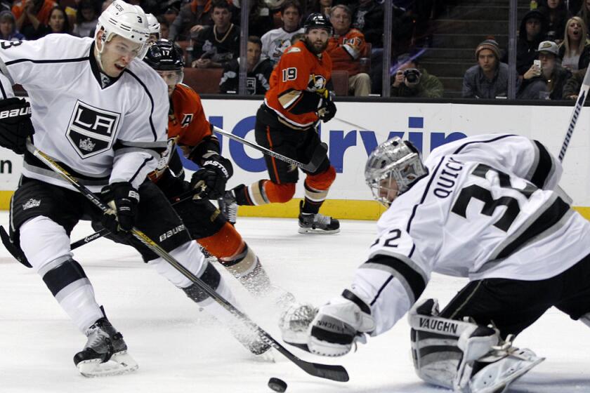 Los Angeles Kings defenseman Brayden McNabb (3) sweeps the puck away from Los Angeles Kings goalie Jonathan Quick (32) as Anaheim Ducks center Ryan Kesler (17) looks on during the second period Sunday night.