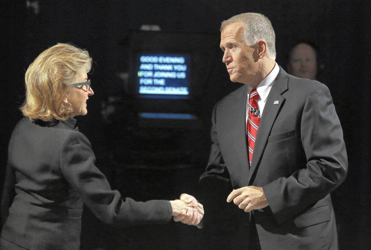 Sen. Kay Hagan (D-N.C.) and North Carolina Republican Senate candidate Thom Tillis shake hands before a televised debate. Outside groups are pouring money into the race.