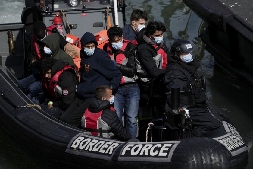 FILE - People thought to be migrants who undertook the crossing from France in small boats and were picked up in the Channel, arrive to be disembarked from a small transfer boat which ferried them from a larger British border force vessel, in Dover, south east England, Friday, June 17, 2022. The suspected ringleader of a network that smuggled as many as 10,000 people on small boats across the English Channel to Britain has been arrested along with 38 others in a vast police operation across Europe, authorities said Wednesday, July 6, 2022. (AP Photo/Matt Dunham, File)
