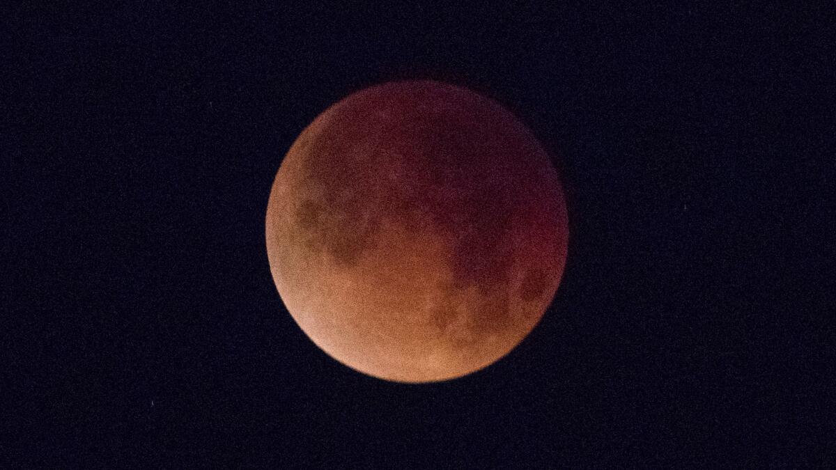 The "super blue blood moon" is viewed from Huntington Beach early Wednesday.
