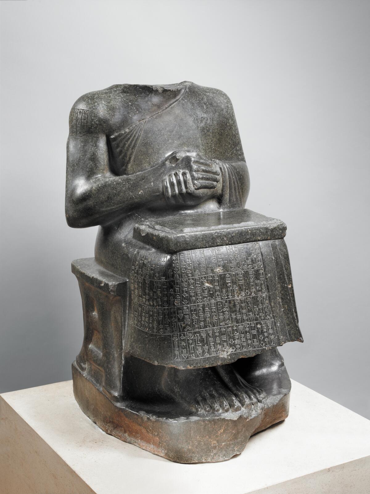 A headless statue of Prince Gudea as an architect.