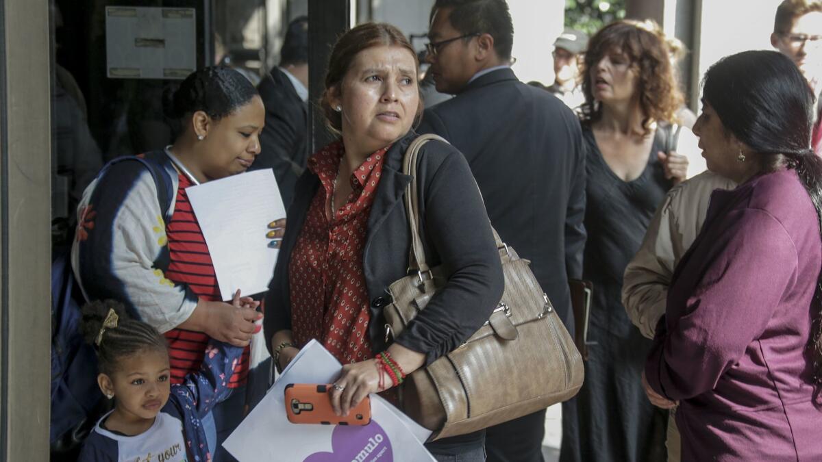 Norma Avélica-González (centro), esposa de Rómulo Avélica-González, se une a otras personas en apoyo a su esposo en el exterior de la Corte Superior del Condado de Los Ángeles (Irfan Khan / Los Angeles Times).