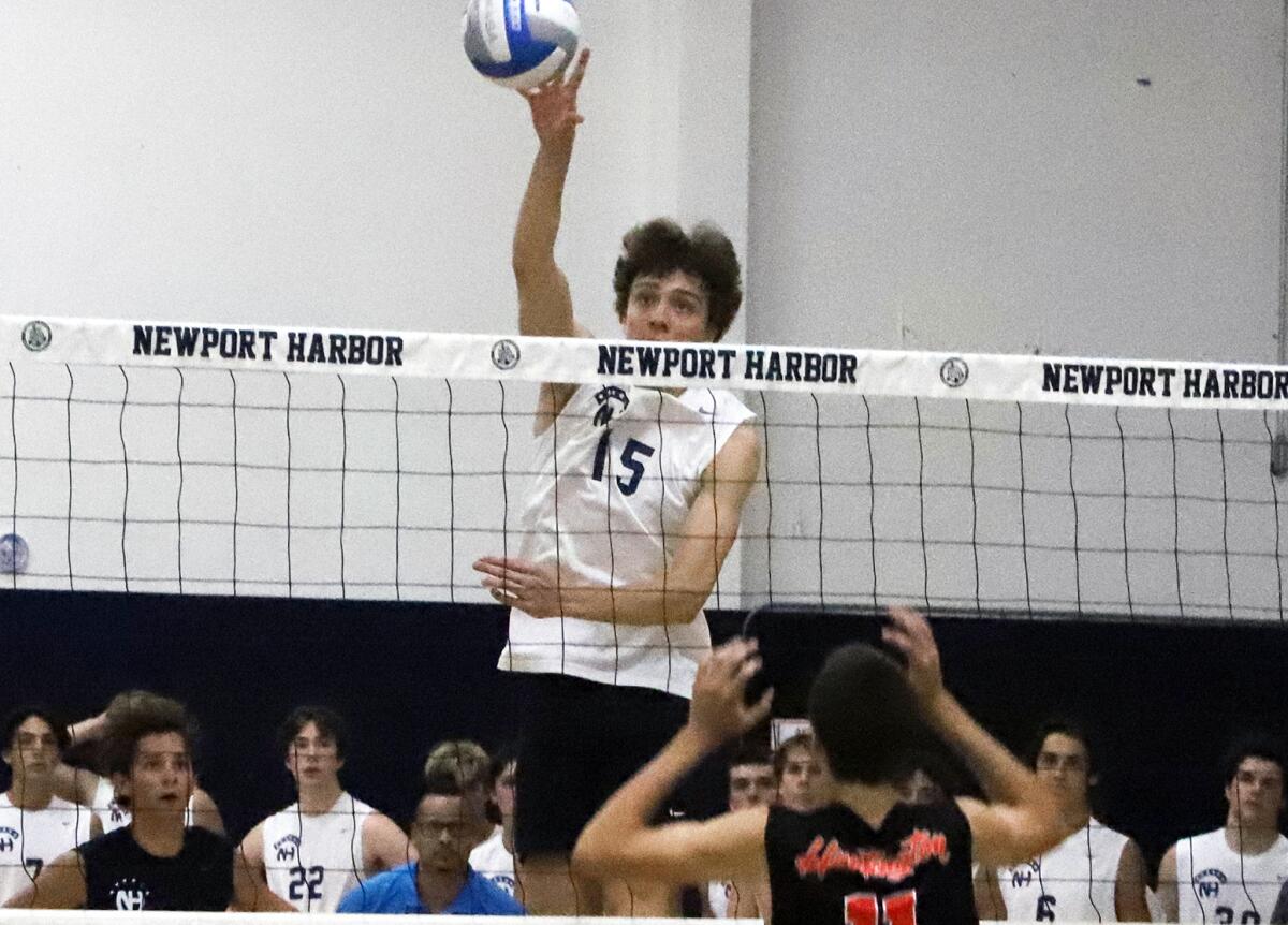 Newport Harbor's Jack Berry (15) taps the ball over the net against Huntington Beach in a CIF Division 1 playoff game.