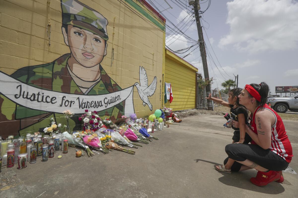 Dawn Gomez and her 3-year-old granddaughter Saryia Greer view a mural honoring Ft. Hood soldier Vanessa Guillén in Houston.