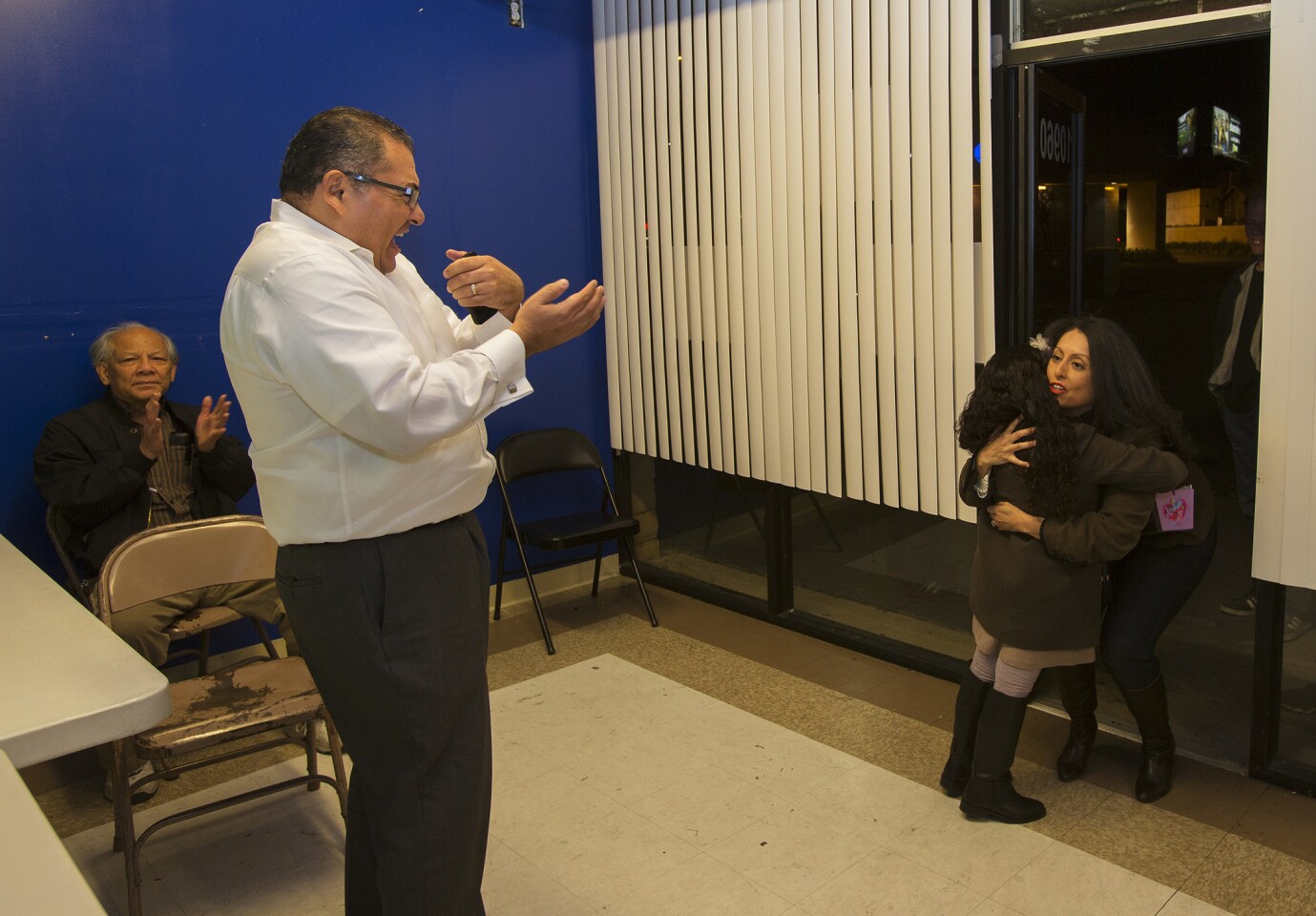 Supporter Pedro Carrillo, left, cheers as Council District 6 incumbent Nury Martinez, with daughter Isabelle, enters her headquarters.
