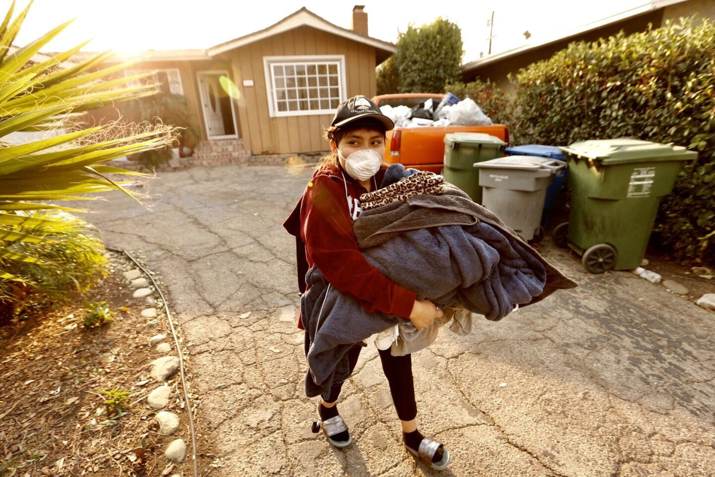 Maria Narvaez evacuates her home on Almon Dr. near Hillcrest in Thousand Oaks as Santa Ana winds continue to blow Friday morning.