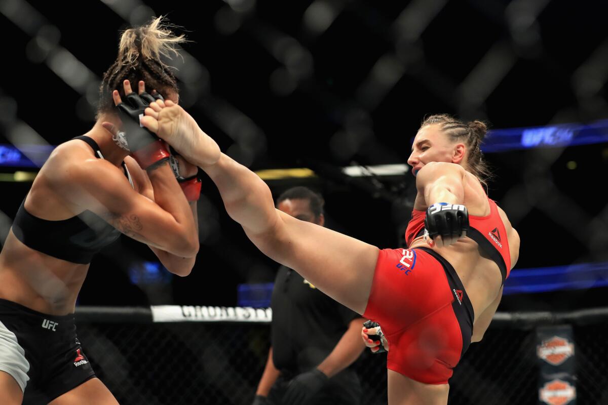 Alexandra Albu attempts to kick Kailin Curran during their strawweight fight at UFC 214.