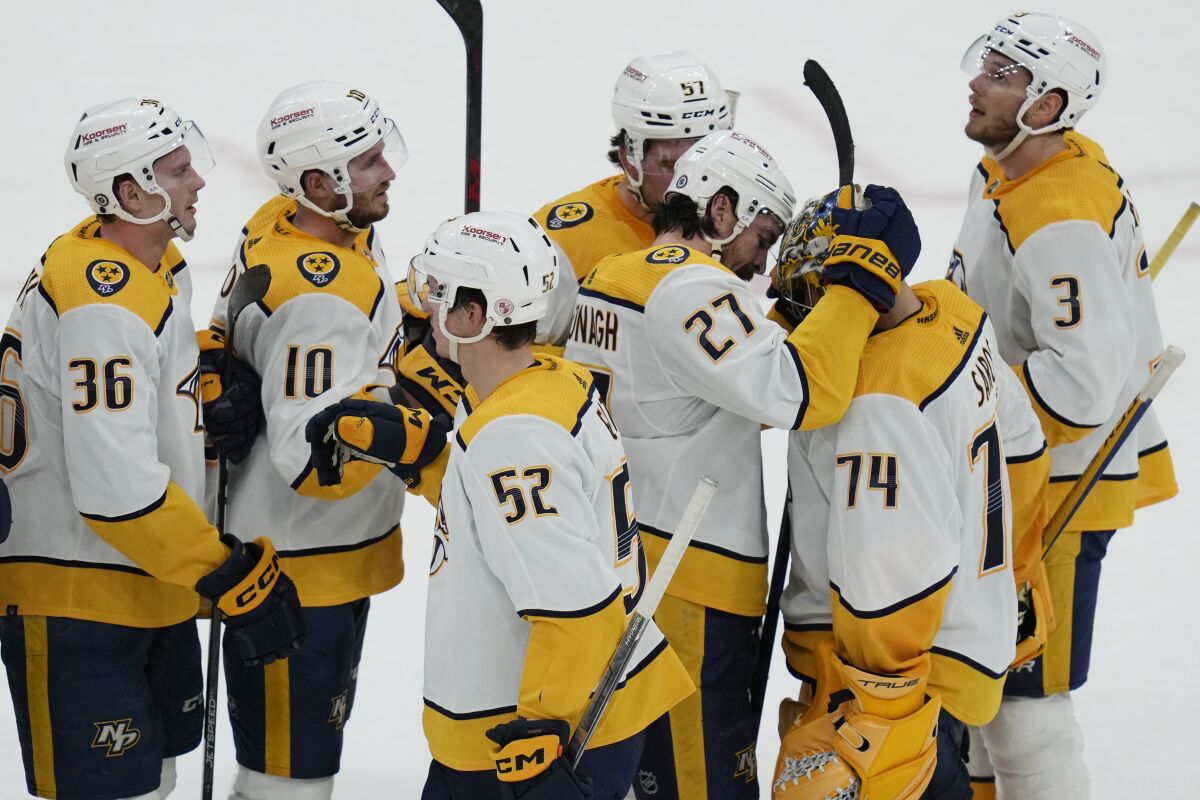 Nashville Predators goaltender Juuse Saros (74) is congratulated after the team's 2-1 win over the Boston Bruins in an NHL hockey game Tuesday, March 28, 2023, in Boston. (AP Photo/Charles Krupa)