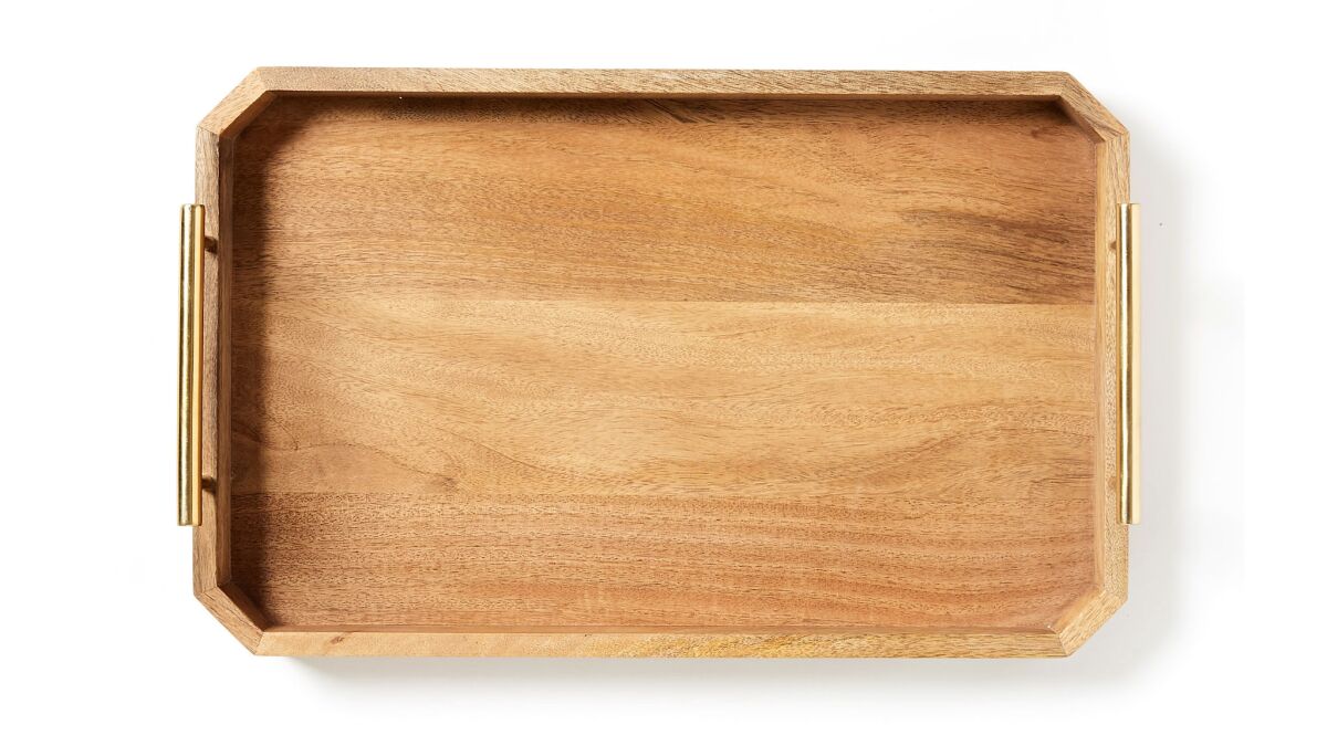 Deco Handle Tray. Made from solid mango wood, West Elmâs brass-finished handled tray blends industrial- and deco-inspired style. Use this multi-tasker to organize your workstation or serve up breakfast in bed. $59 and $89. westelm.comPhoto credits: West Elm