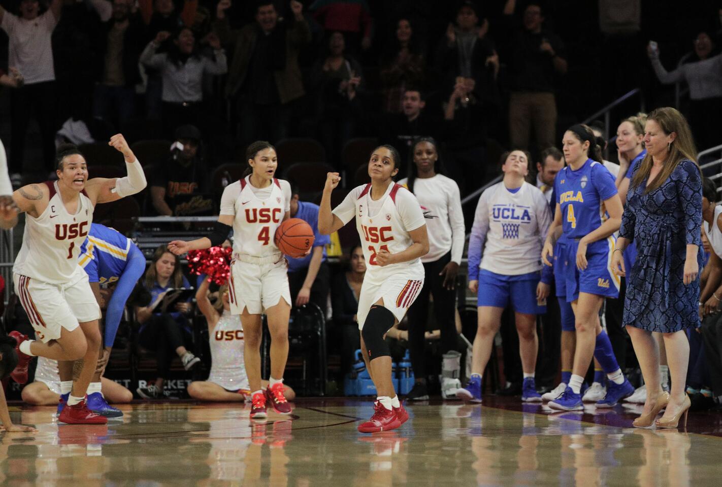 USC forward Kayla Overbeck (1) and guards Endyia Rogers (4) and Desiree Caldwell (24) react after handing UCLA its first loss of the season in double overtime at Galen Center.