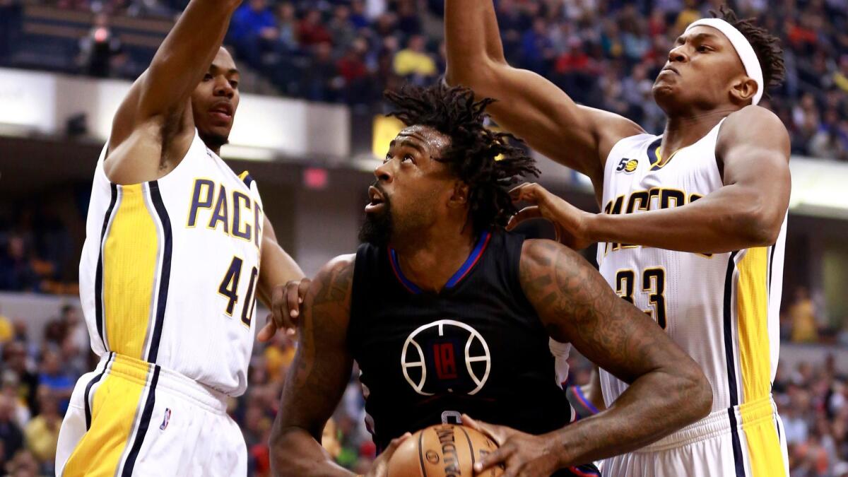 Clippers center DeAndre Jordan attempts to shoot between Indiana's Glenn Robinson III, left, and Myles Turner on Nov. 27.
