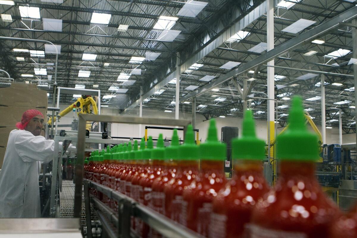 Manuel Benitez works in the packaging area at Huy Fong Foods' Sriracha factory in Irwindale.