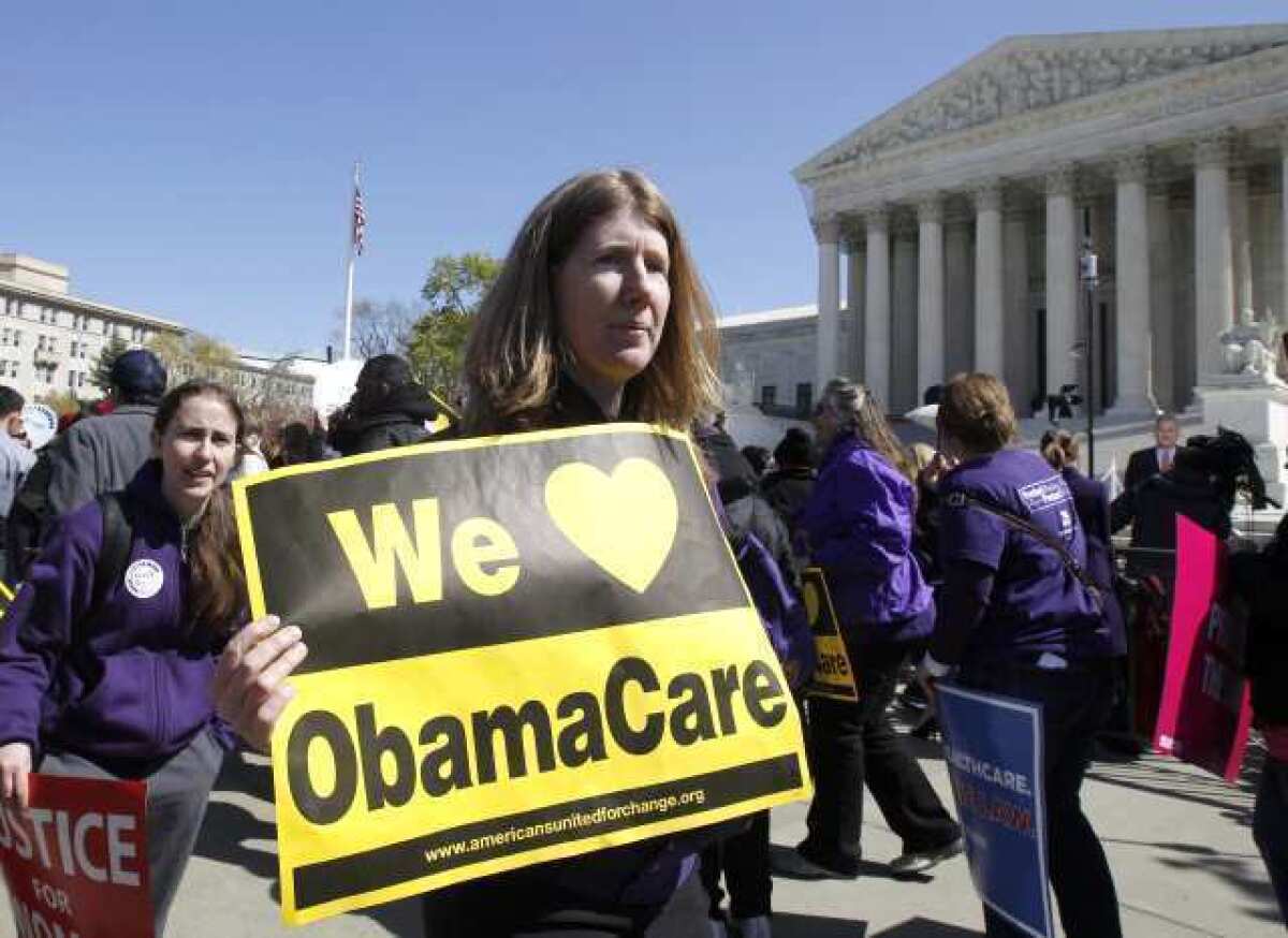 Supporters of President Obama's healthcare overhaul rally in front of the Supreme Court as the justices hear oral arguments on the 2010 reform law.