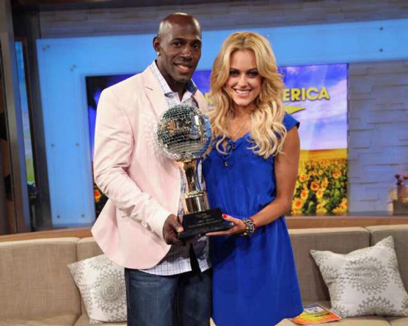 Donald Driver and "Dancing With the Stars" partner Peta Murgatroyd hold the Mirror-Ball Trophy.