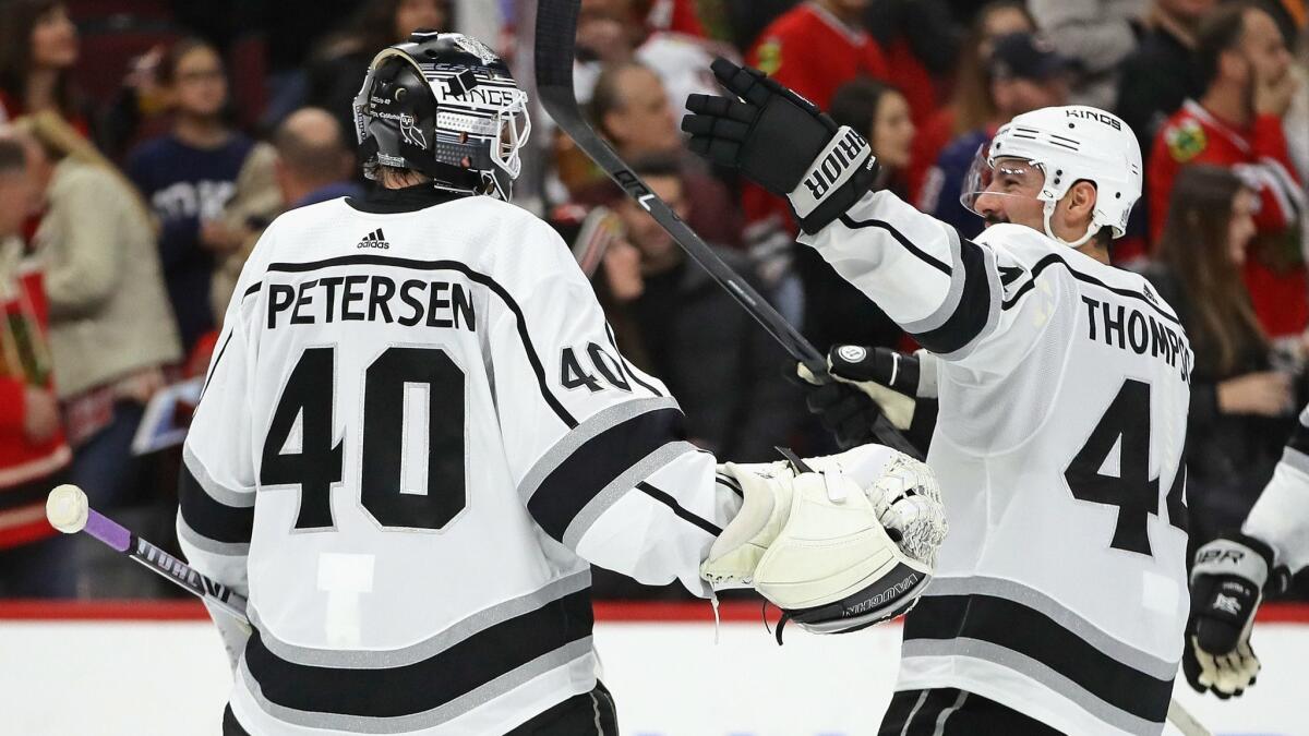 Kings' Nate Thompson (44) skates up to congratulate Calvin Petersen (40) after a win over the Chicago Blackhawks at the United Center on Friday in Chicago.